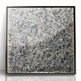 Framed acrylic artwork showcasing a vibrant abstract design with colorful splatters on a black background, perfect for modern home decor or art enthusiasts.