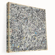Abstract splatter art on stretched canvas showcasing vibrant colors and dynamic shapes, ideal for modern home decor. Side view highlights depth and texture.