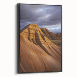 Framed canvas artwork depicting a stunning desert landscape with warm earth tones, featuring a black frame and a side view showcasing its elegant design. Perfect for home decor enthusiasts.