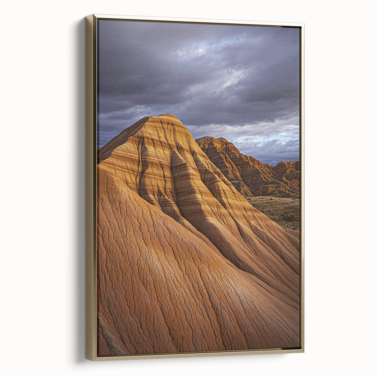 Framed canvas artwork showcasing a stunning desert landscape with golden hues and intricate details, elegantly displayed in a sleek gold frame, perfect for home décor.