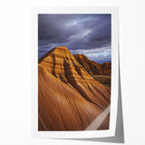 Desert landscape rolled print showcasing vibrant hues of orange and gold, depicting a serene sunset over sand dunes, elegantly packaged in a protective cardboard tube.