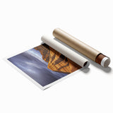 Desert landscape rolled canvas print showcasing vibrant hues of orange and yellow, depicting a serene sunset over sand dunes, packaged securely in a cardboard tube.