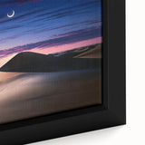 Close-up of a framed canvas depicting serene desert dunes at sunset, showcasing warm hues of orange and gold, perfect for enhancing home decor with a natural theme.