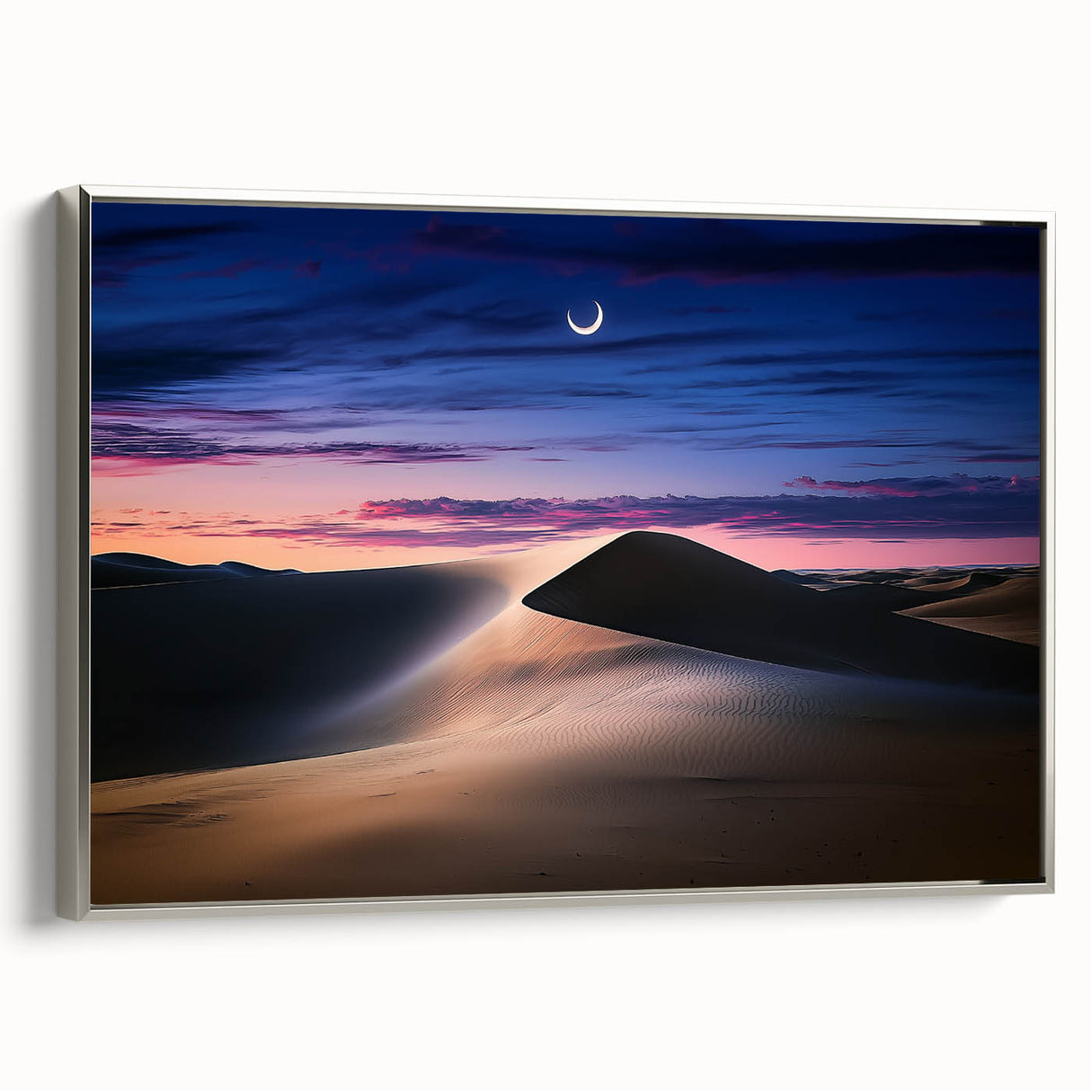 Framed canvas artwork displaying an abstract landscape of golden dunes under a vibrant sunset, featuring a sleek silver frame that enhances its modern aesthetic.