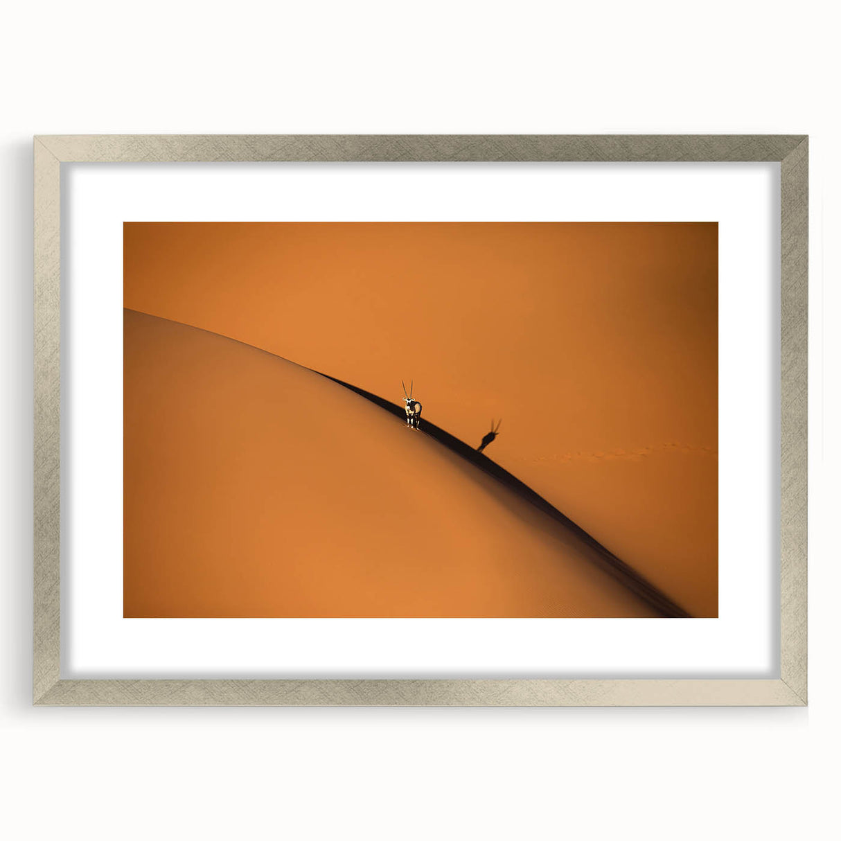 Abstract art print depicting a serene Namibian landscape in muted earth tones, framed in silver.