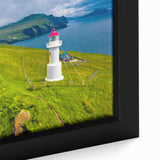 Close-up of a textured black wall art piece depicting a colorful European scenery on a framed canvas.