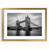 Abstract art print of London skyline in muted gold and black tones on a framed canvas.