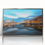 Large art print of a serene Finnish landscape in muted blue and green tones, framed in silver acrylic.