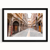 Colorful abstract art print of Lyon scenery in vibrant hues on a large textured canvas, framed in black.