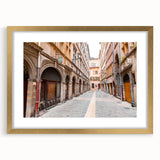 Abstract art print of Lyon, France in muted gold and blue tones on a framed canvas.