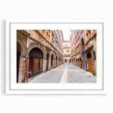 Textured abstract art print of Lyon scenery in muted earth tones on a framed white mat, ideal for bedroom wall decor.