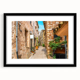 Extra large abstract art print of a vibrant, colorful European scenery on textured canvas, framed in black.
