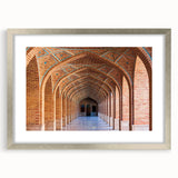 Textured art print depicting an abstract Middle Eastern scenery in muted earth tones, framed with a silver mat.