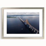 Textured art print featuring abstract shapes in earthy tones, framed in silver, ideal for bedroom wall decor.