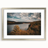Textured abstract art print of Arkansas scenery in muted earth tones, framed with a silver mat, suitable for bedroom decor.