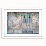 Abstract art print of New Orleans scenery in muted earth tones on a framed white mat, suitable for dining room decor.