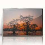 Mid-century modernist art depicting a Louisiana landscape in muted green and blue tones, framed in silver acrylic.