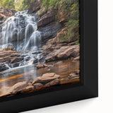 Close-up of a framed canvas depicting a textured West Virginia scenery in black with colorful art accents.