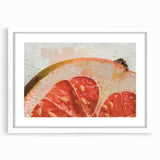 Abstract art print of assorted fruits in vibrant colors on a white-framed mat, suitable for dining room decor.