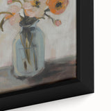 Close-up of a vibrant abstract floral canvas print showcasing bold colors like pink, blue, and green, elegantly framed to enhance decor aesthetics.