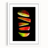Abstract art print featuring assorted fruits in vibrant colors on a white framed mat, ideal for dining room decor.