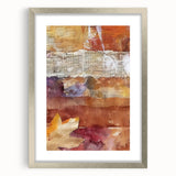 Textured abstract art print in warm autumn hues on a silver-framed canvas, ideal for bedroom ambiance.