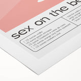 Art deco poster featuring a stylized cocktail glass, in black and gold tones, on a rolled canvas.