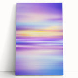 Abstract landscape stretched canvas artwork showcasing vibrant hues of blue, orange, and green, leaning against a neutral wall, perfect for modern home decor.
