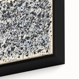 Close-up of a framed canvas featuring vibrant abstract splatter designs in bold colors, ideal for modern home decor, enhancing artistic spaces with visual energy.