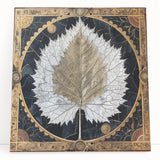 Colorful stretched canvas artwork showcasing an intricate design of flowers and botanical leaves, elegantly leaning against a wall, perfect for home decor.