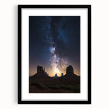 Framed landscape artwork showcasing a serene desert scene, featuring warm hues of orange and brown, with a sleek black frame and matting, perfect for home decor.