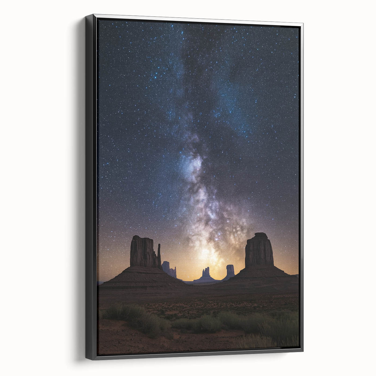Framed canvas artwork showcasing a vibrant desert landscape with warm hues of orange and yellow, elegantly displayed with a sleek black frame, perfect for modern decor.