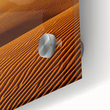 Close-up of a textured acrylic glass artwork depicting vibrant desert dunes, showcasing warm tones of orange and yellow, perfect for modern home decor.