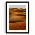 Framed landscape artwork showcasing serene sand dunes in neutral tones, presented with a black mat, ideal for modern home decor or office aesthetics.