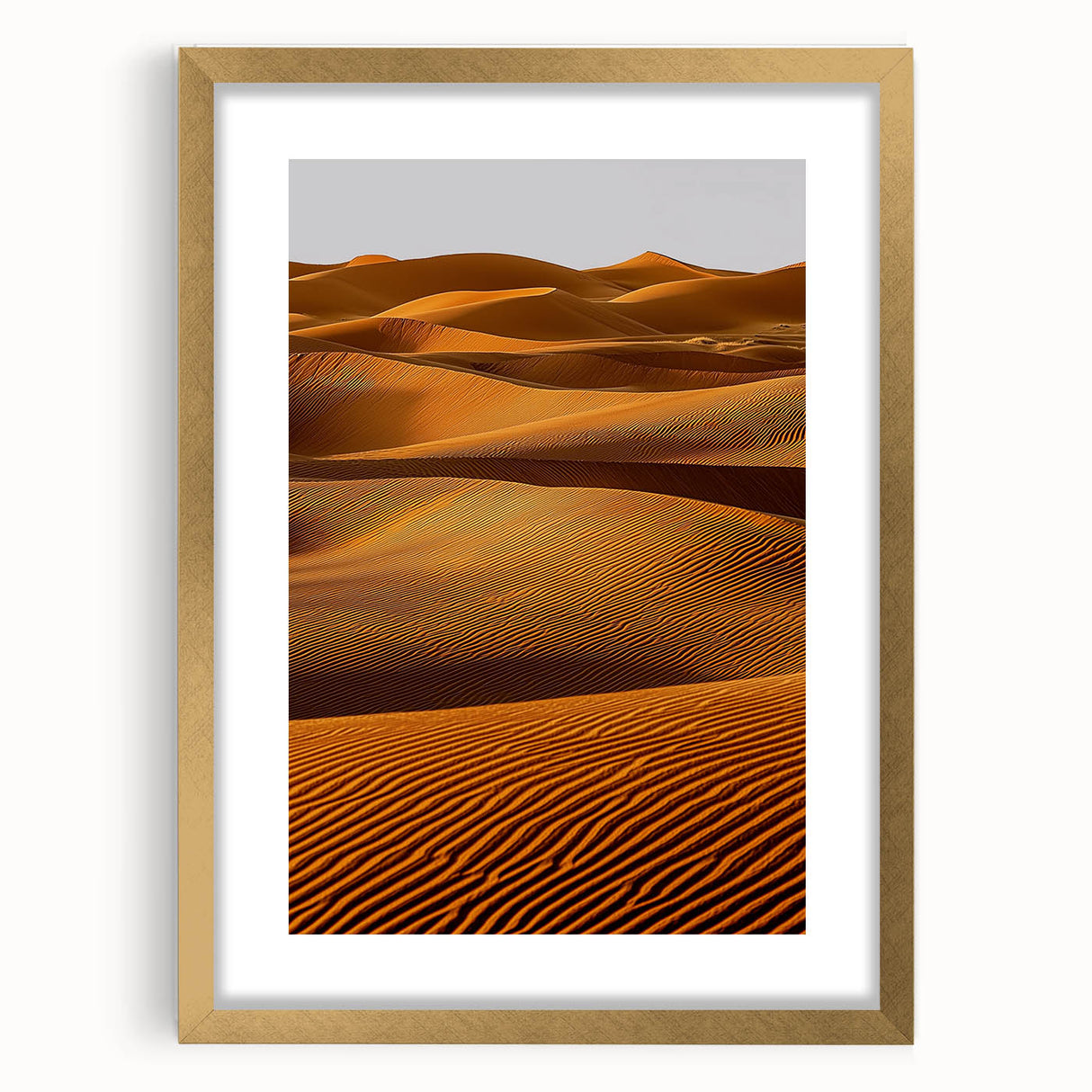 Elegant gold-framed landscape artwork depicting serene sand dunes, accentuated with a white mat border, perfect for home decor and enhancing interior aesthetics.