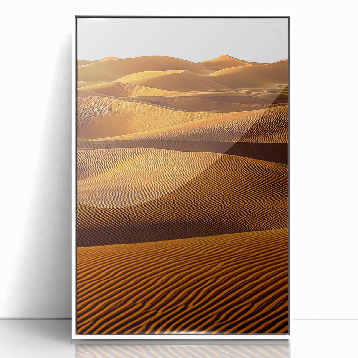 Framed acrylic artwork depicting serene dunes landscape in soft beige and blue tones, displayed in a sleek white frame for modern home decor.