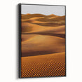 Framed canvas artwork showcasing a serene desert landscape with rolling dunes, presented in a sleek black frame, ideal for modern home decor. Perfect for enhancing interior aesthetics with a touch of nature's beauty.