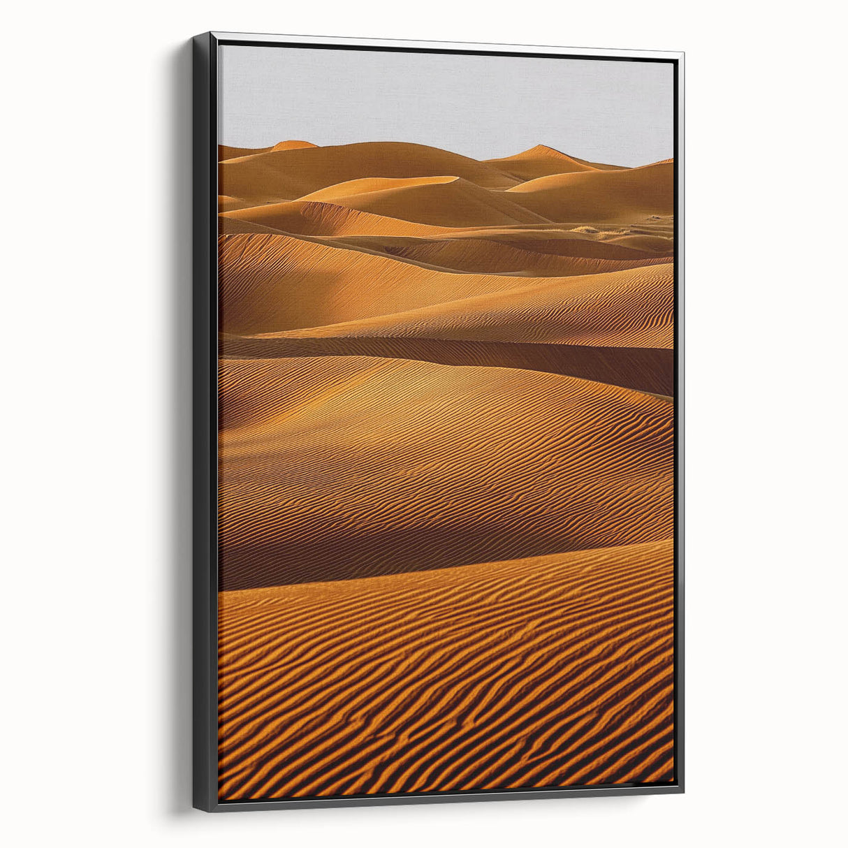 Framed canvas artwork showcasing a serene desert landscape with rolling dunes, presented in a sleek black frame, ideal for modern home decor. Perfect for enhancing interior aesthetics with a touch of nature's beauty.
