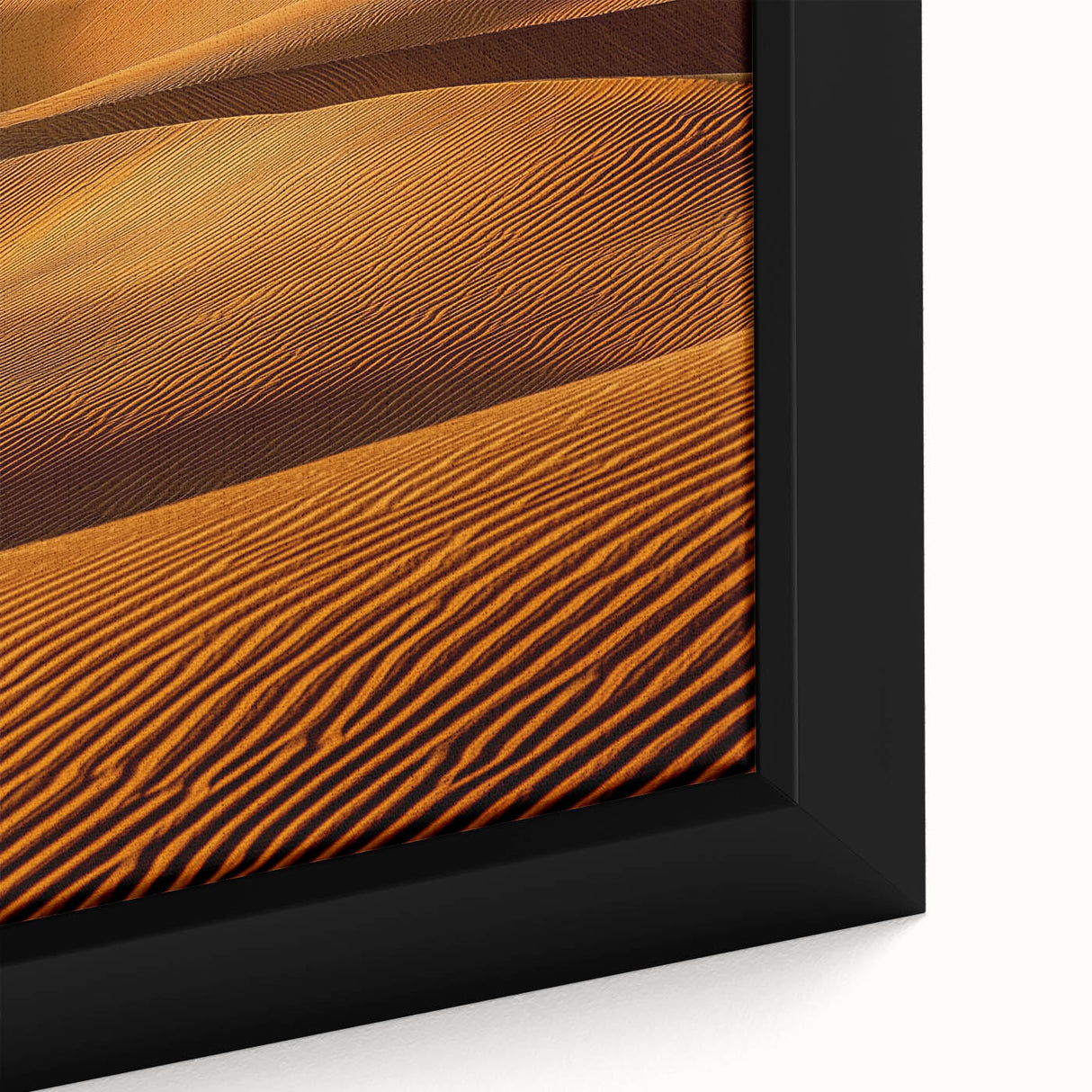 Close-up of a framed canvas artwork showcasing serene sand dunes at sunset, highlighting warm golden hues and intricate textures, perfect for home decor.