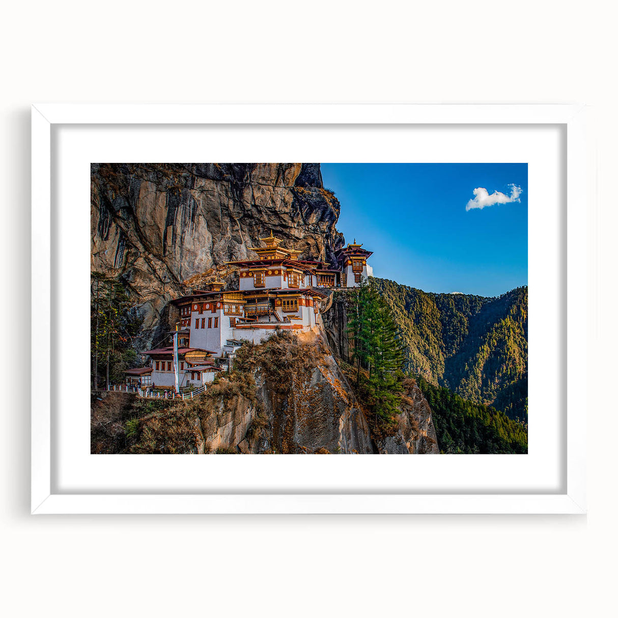 Abstract art print of Bhutan scenery in muted earth tones on a framed white mat, suitable for bedroom or dining room decor.