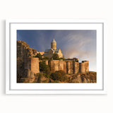 Abstract art print depicting vibrant shades of blue and orange, framed with a white mat, ideal for dining room decor.