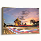 Framed canvas featuring a vintage-style landscape painting of a Laotian scenery in muted gold and black tones.