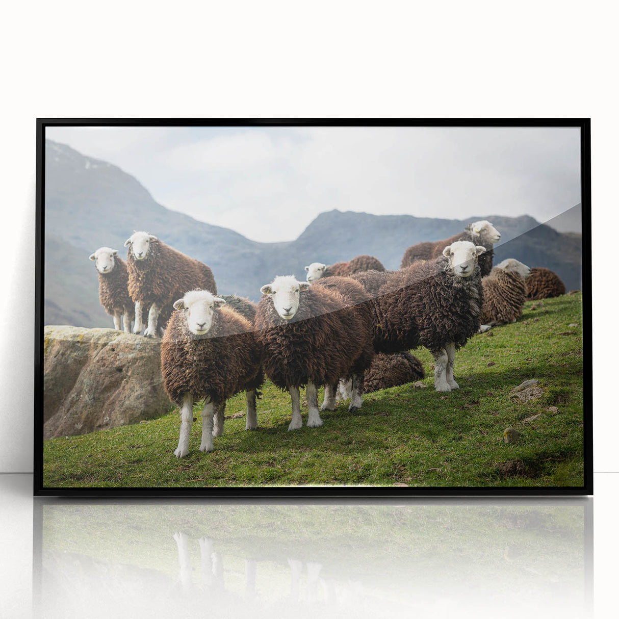 Large abstract wall art depicting a serene Cumbrian landscape in muted green and blue tones, framed in black acrylic.