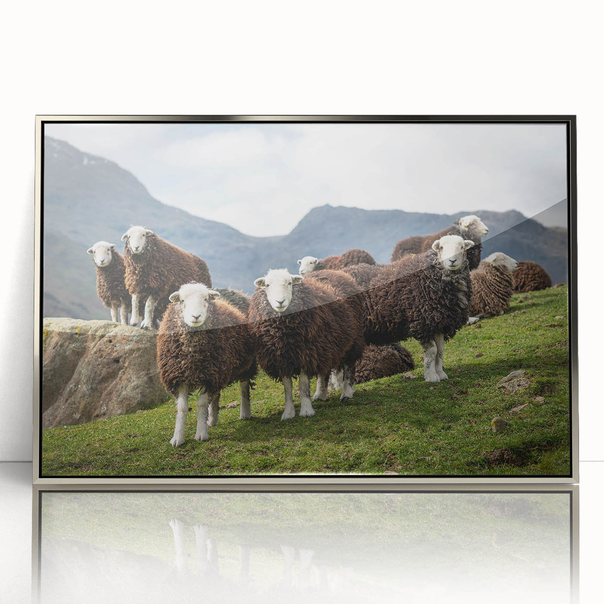 Large art print featuring a serene Cumbrian landscape in muted greens and blues, framed in silver acrylic.