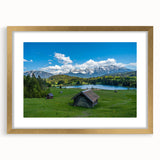 Abstract art print of a Bavarian landscape in muted green and blue tones, framed in gold.