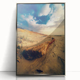 Large art print of a European Lithuanian landscape in muted earth tones, framed in silver acrylic.