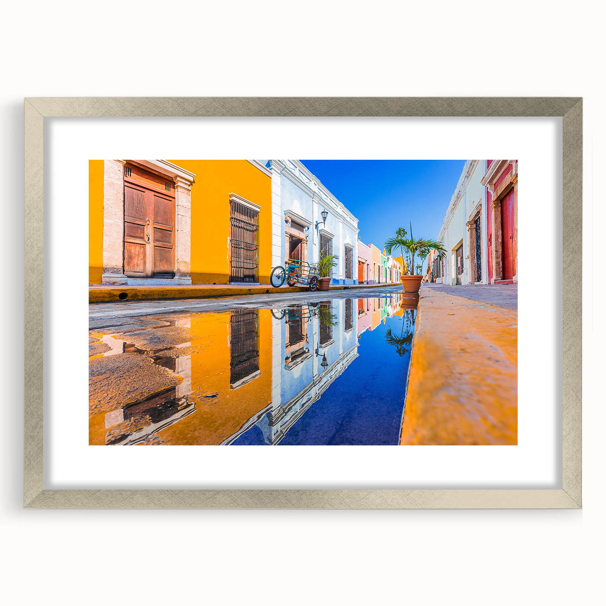 Textured abstract art print of Yucatan scenery in muted earth tones, framed in silver, ideal for bedroom decor.