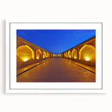 Abstract art print depicting a Middle Eastern scenery in muted earth tones on a framed white mat.