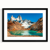 Abstract art print featuring vibrant, colorful textures, framed in black, ideal for living room decor.