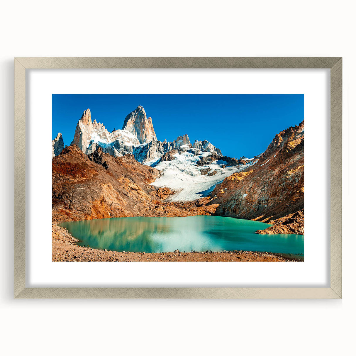 Textured abstract art print of an Argentine landscape in muted earth tones, framed in silver, suitable for bedroom decor.